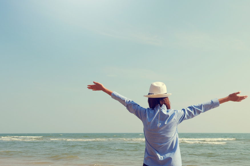 Young Woman Standing Arms Outstretched Back and Enjoy Life on Th